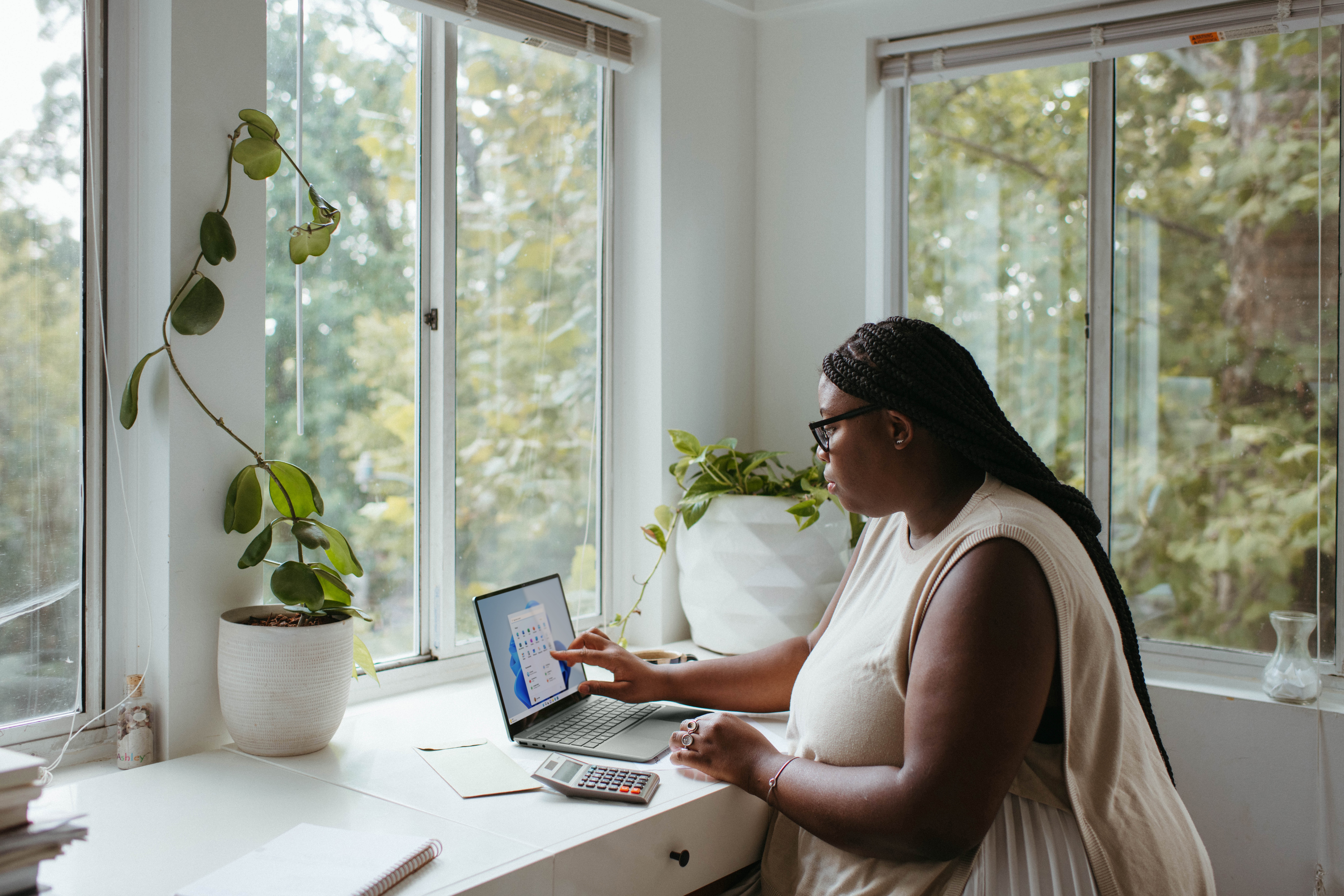 Woman working from home in a well lit office