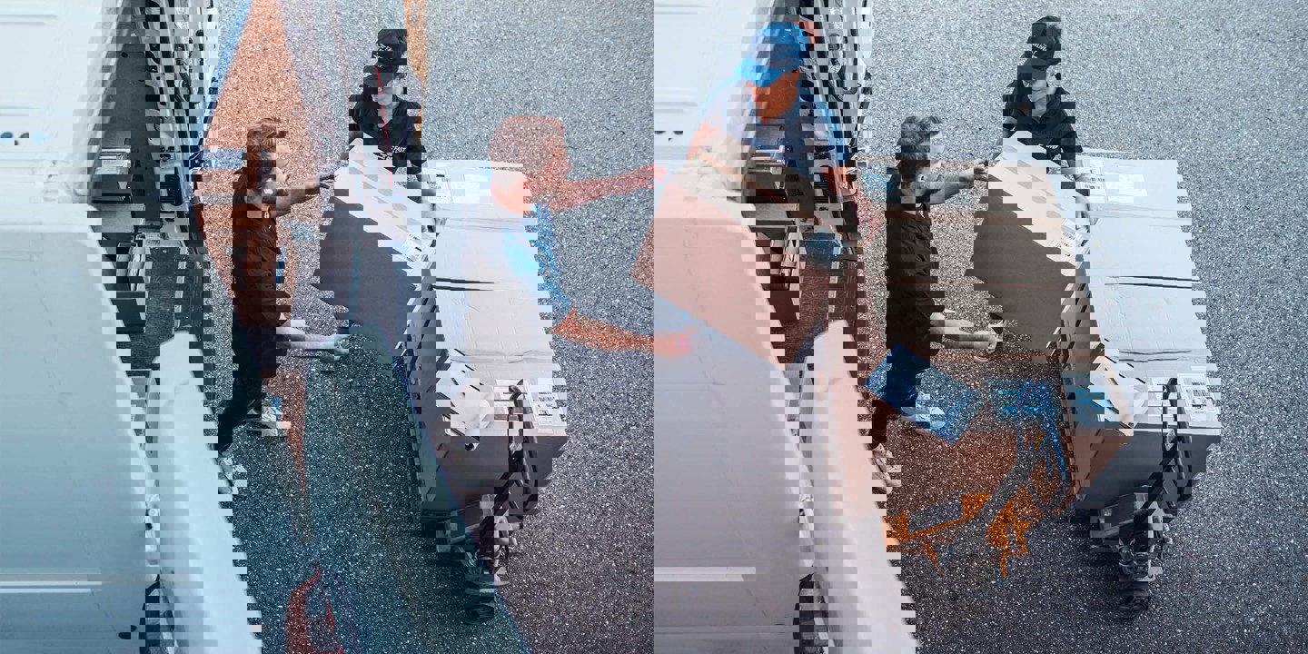 Woman handing box to man